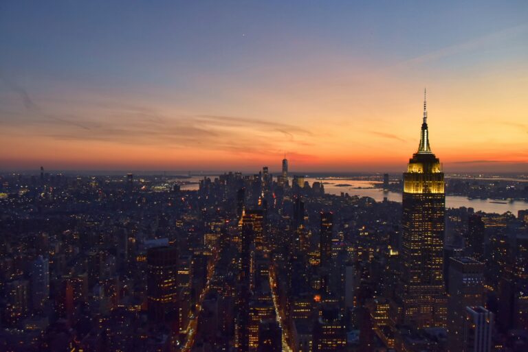 Manhattan skyline with the Empire State Building lit at sunset, destination of American investor and business visas