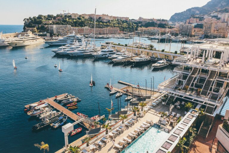 Elevated view over Port Hercule marina in Monte Carlo with superyachts moored beneath the hills of Monaco, a favoured base for private wealth