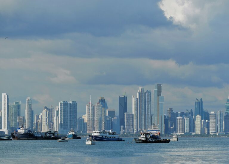 Skyscrapers of Panama City rising across the bay with boats in the foreground, hub of the Friendly Nations visa and Qualified Investor residency