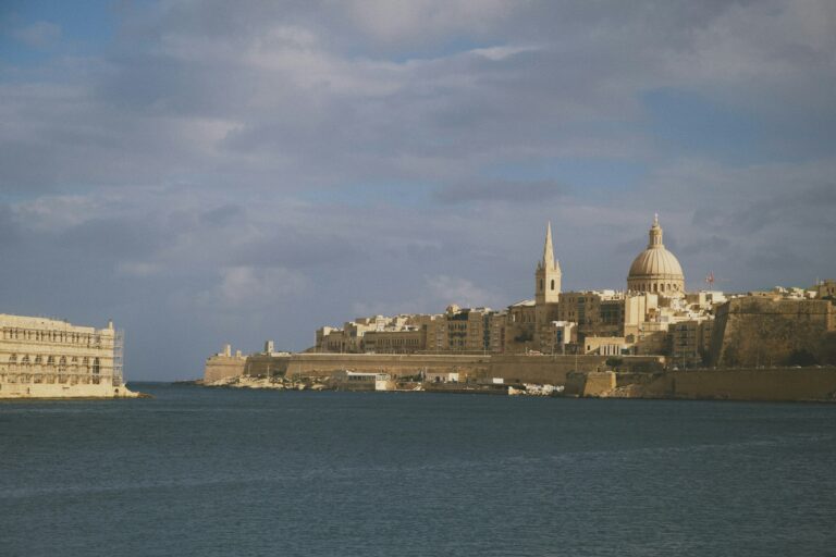 Valletta skyline with cathedral dome and spire rising above the Grand Harbour, gateway to Malta residence by investment