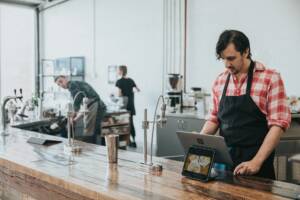 A cafe owner working behind the counter