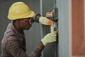 A tradesman in a hard hat at work